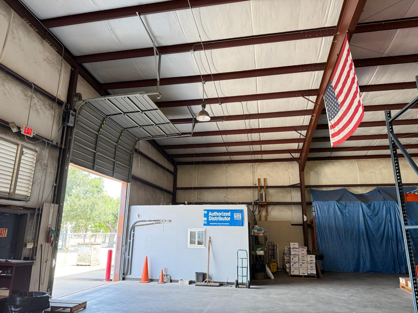 TikTak technician servicing a commercial overhead door at a Houston business