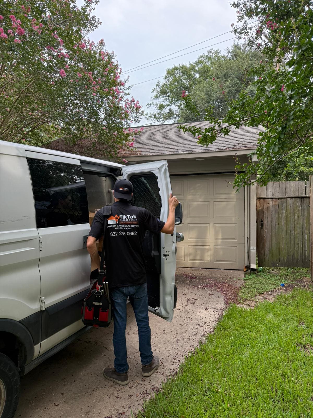 TikTak technician unloading tools for a garage door repair