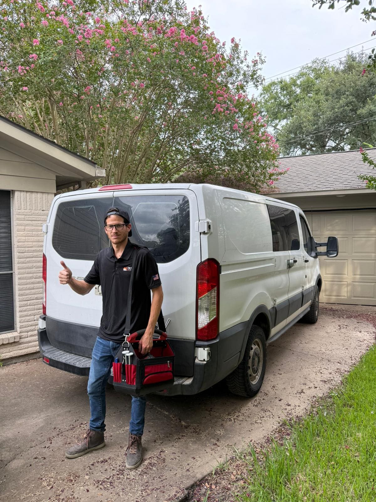 TikTak garage door technician with the service van at a Houston home